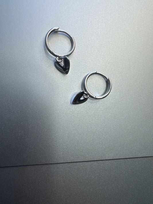 Heart dangle circular hoop on a silver surface