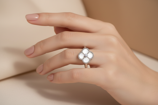 Elegant hand wearing clover ring - close-up detail