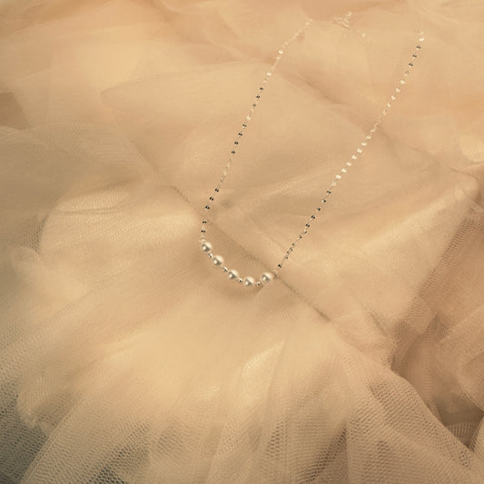 Necklace on a textured beige fabric background