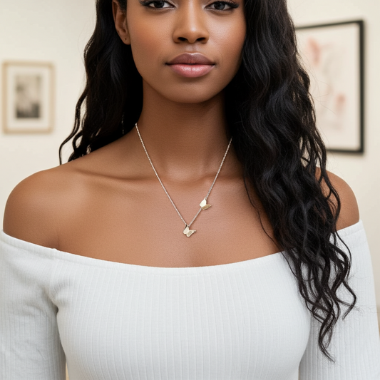 Woman wearing a gold necklace with a white top indoors