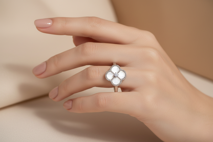 Elegant hand wearing clover ring - close-up detail